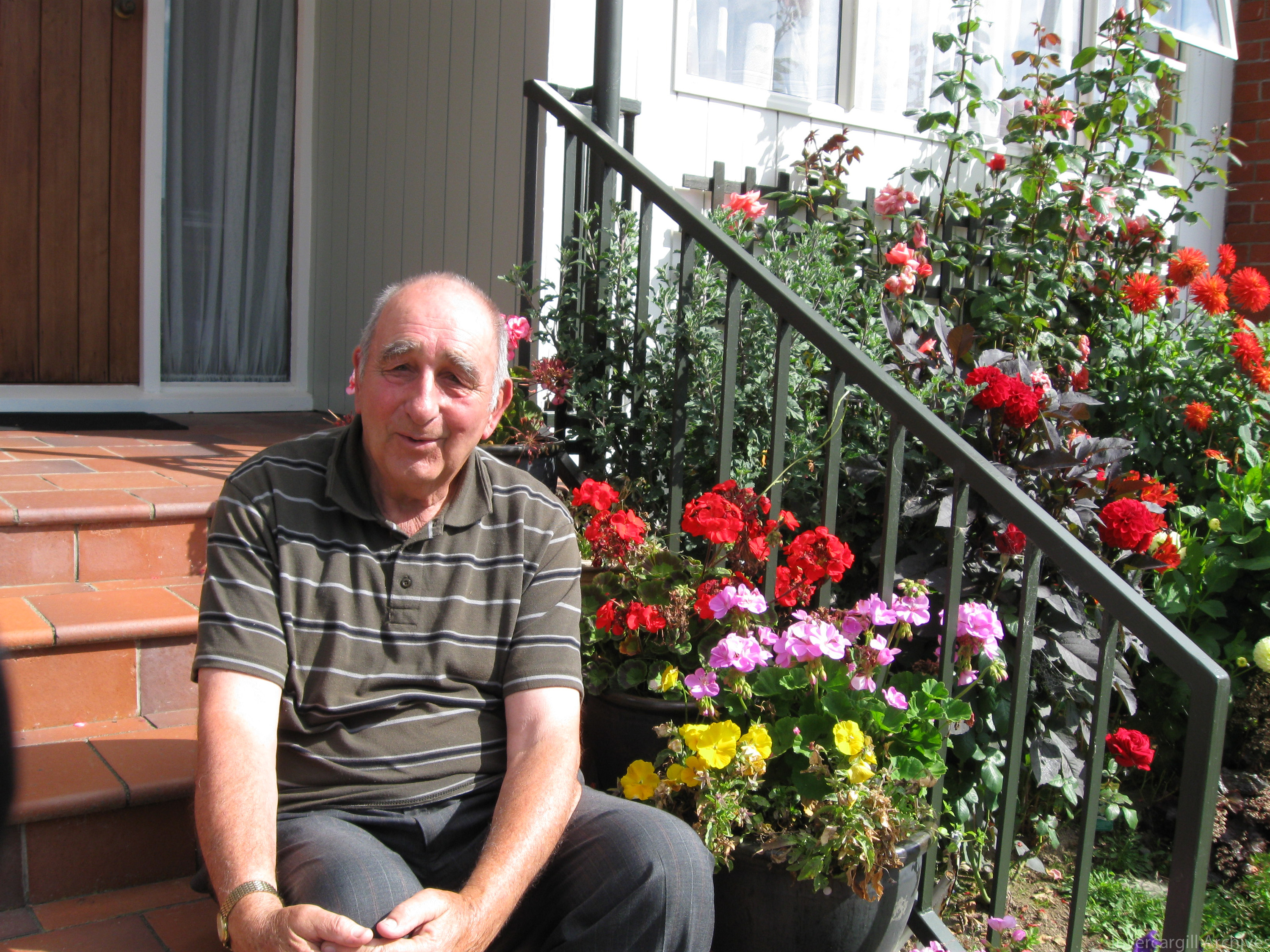Colin Gray sitting on steps in garden